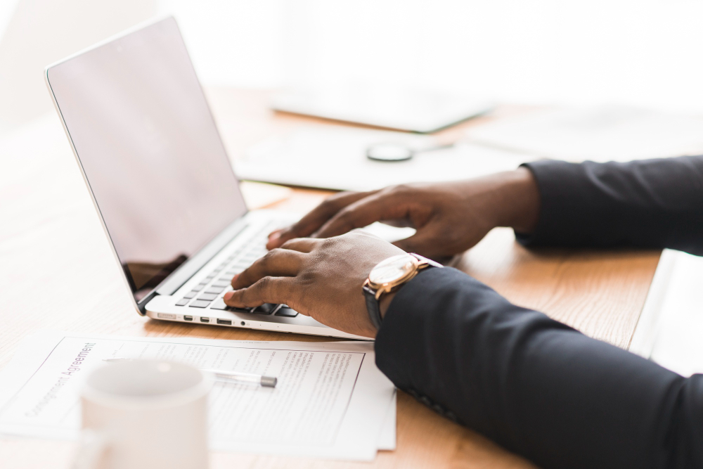 Ethnic hands typing on laptop