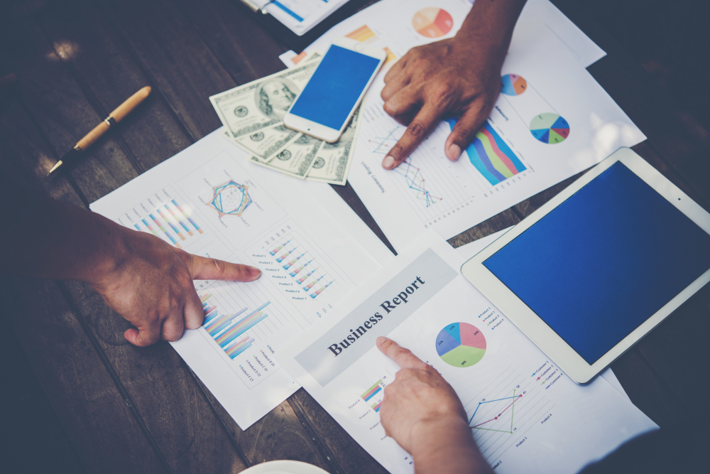 Group of business people analysis with marketing report graph at Syllah & Partners